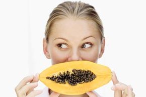 young woman with sliced papaya