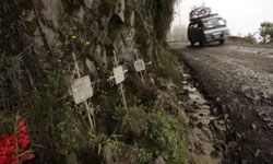 A van descends past a series of crosses marking the site of fatal accidents on the most dangerous road in the world -- Old Yungas.
