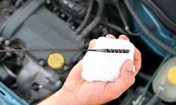 Use the oil change interval recommended by your car's manufacturer to decide when to change the oil, not the color of the oil on the stick.