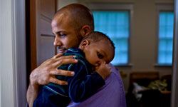 african american father holding child