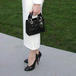 Dita Von Teese ties together her black and white ensemble with a tiny Lady Dior bag.
