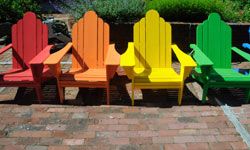 Colorful Adirondack chairs will add a pop of personality to an outdoor space.