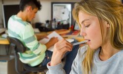 student chews on pen