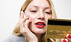 Woman holding phone and credit card