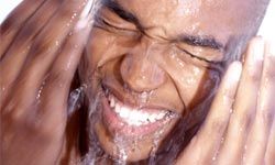 Man splashing water on face