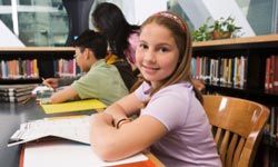 middle school-aged girl sitting at desk