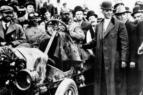 The first transcontinental car race from New York to Seattle was held in 1909 — Henry Ford's Model T won. The trip took 22 days and 55 minutes at an average speed of just 7.75 mph. (Henry Ford is shown standing next to the car.)