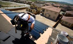Workers install SunTiles onto homes in San Ramon, Calif.