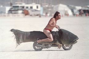 A Catmobile can't be far behind this fleeing trout bike at the Burning Man festival.