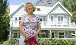 senior woman in front of her home