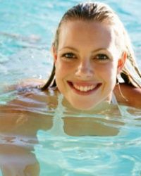 Swimming a few laps in the pool may be fun, but it's not good for your tooth enamel.