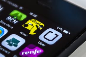 Logos of 'Uber,' a Barcelona taxi service and Barcelona City guide apps are seen on a smartphone display in Barcelona, Spain.