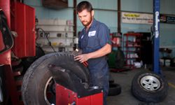 Merle King works on balancing a tire at Bagsby Tractor and Truck repair shop in Spring Hill, Tenn.