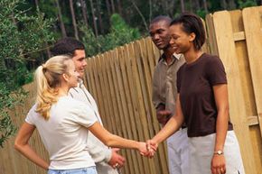 Neighbors meeting and shaking hands.