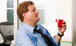 Businessman with a handheld fan