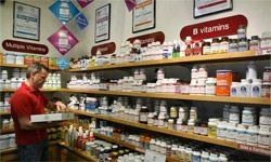 Guy stocking shelves with vitamins