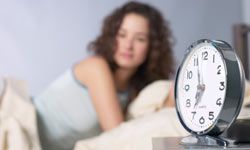 Woman awaken by alarm clock