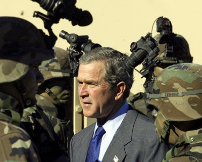 US President George W. Bush greets US Army soldiers that are members of a special night operations unit all wearing night vision equipment at Fort Hood, Texas.