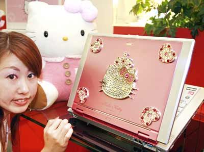Japan's computer giant NEC employee Ayumi Tamotsu displays the new notebook PC 'LaVie G Hello Kitty', decorated with Swarovski crystals shaped character of Hello Kitty.