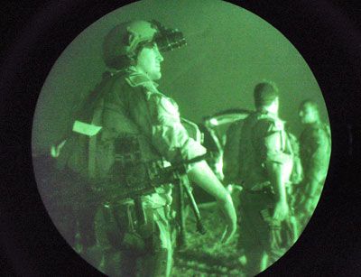 U.S. Navy SEALS await a night mission to capture Iraqi insurgent leaders.