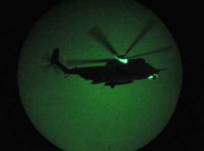 A U.S. Special Forces MH-53 helicopter arrives to take U.S. Navy SEALS on a night mission to capture Iraqi insurgent leaders.
