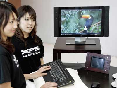 Dell employees introduce the all-in-one desktop PC 'XPS One', at a global launching in Tokyo.