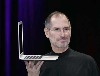 Apple CEO and co-founder Steve Jobs holds up the new Mac Book Air after he delivered the keynote speech to kick off the 2008 Macworld.