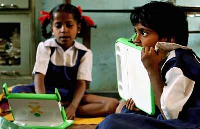 students work on their One Laptop per Child (OLPC) laptops at Vasti Vidhalaya- a Marathi medium school in India.