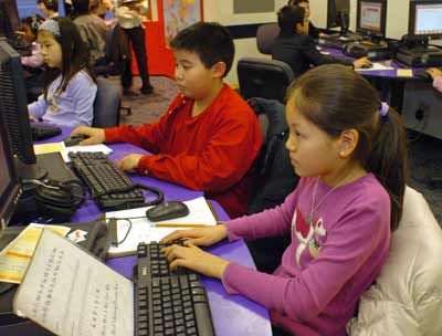 From right to left, fifth graders Michelle Fei (10 yrs old), Alex Wong (10yrs.old), and fourth grader Ray Ouchi (9yrs.old), sit at their computers during an after-school learning program at SCORE! Educational Center in Manhattan, New York.