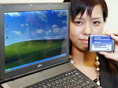 Fujitsu employee Miho Hirasawa displays the company's new notebook PC 'FMV-Lifebook FMV-Q8230', equipped with Intel's 1.2 GHz Core Solo processor on its CPU and the company's first 32GB flash memory drive (SSD) instead of a harddisk drive (HDD).