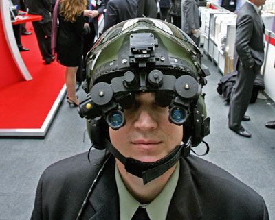 A man demonstrates night vision goggles at the 'Building a Secure World Convention' at Kensington Olympia, in London.