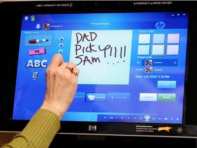 A Hewlett Packard employee demonstrates an HP Touchsmart PC.