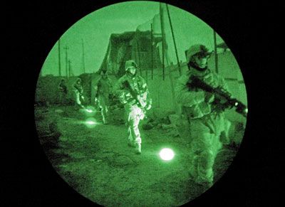 Using infrared lasers only seen with night vision goggles, U.S. Marines set out on a search operation for insurgents during the early hours in Iraq.