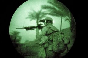A U.S. Marine uses night vision goggles while on a search operation in the early hours in Iraq's Anbar province.